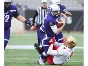 Laval Rouge et Or Mathieu Betts (9) sacks Western Mustangs quarterback Chris Merchant (12) during first-half Vainer Cup football action between the Western Mustangs and the Laval Rouge et Or in Hamilton, Ont., on Saturday, November 25, 2017. THE CANADIAN PRESS/Peter Power