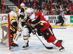 Derick Brassard #19 of the Ottawa Senators battles for position against Brian Dumoulin #8 of the Pittsburgh Penguins in front of Matt Murray #30 at Canadian Tire Centre on Thursday. (Photo by Andre Ringuette/NHLI via Getty Images)