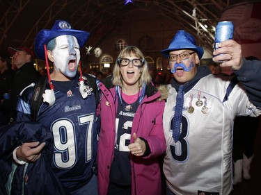 Appearances suggest the Argos have the support of these fans, left to right, Mark Bottaro, Debbie Geldart and Mark Geldart. David Kawai/Postmedia