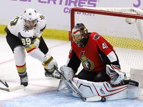 Golden Knights winger Alex Tuch shoves the puck past Senators goalie Craig Anderson to score the opening goal of Saturday's game.