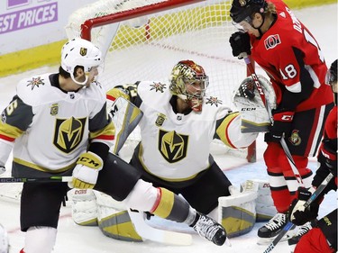 Vegas Golden Knights goalie Maxime Lagace makes a glove save as defenceman Colin Miller (6) and Ottawa Senators left wing Ryan Dzingel (18) look on.