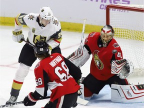 Vegas Golden Knights left wing Tomas Nosek (92) and Ottawa Senators goalie Craig Anderson (41) keep their eyes on a flying puck as left wing Mike Hoffman (68) looks on.