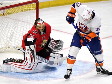 Senators goaltender Craig Anderson makes a pad save as the Islanders' Anders Lee looks for a rebound during the second period. THE CANADIAN PRESS/Justin Tang