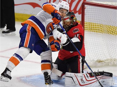 The Islanders' Anders Lee gets in the way of Senators goaltender Craig Anderson as he makes a save during the first period. THE CANADIAN PRESS/Justin Tang