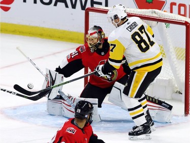 Pittsburgh Penguins centre Sidney Crosby (87) tries to tip a puck in front of Ottawa Senators goalie Craig Anderson.