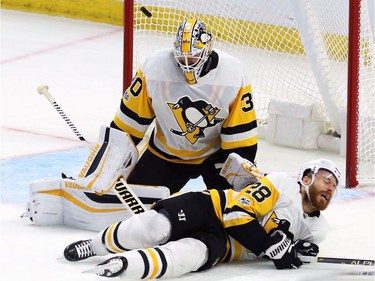 Pittsburgh Penguins defenceman Ian Cole blocks a shot in front of goalie Matt Murray.