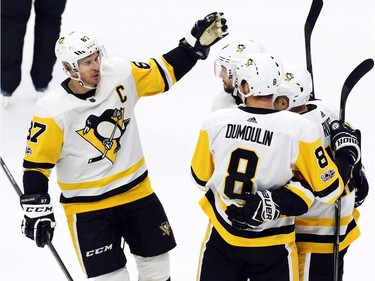 Pittsburgh Penguins' Sidney Crosby, left, celebrates a goal against the Ottawa Senators with teammates Kris Letang, left to right, Brian Dumoulin and Bryan Rust.