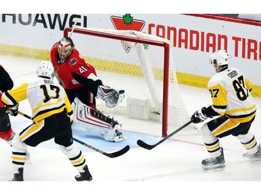 Ottawa Senators goaltender Craig Anderson (41) attempts to make a save as the Pittsburgh Penguins' Sidney Crosby (87) and Bryan Rust (17) look on during the third period.