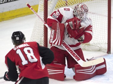 Detroit Red Wings goalie Jimmy Howard makes a save on a shot from Ottawa Senators left wing Ryan Dzingel.