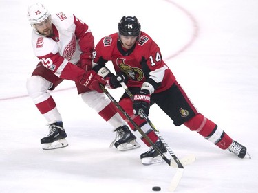 Ottawa Senators right wing Alexandre Burrows battles for control of the puck with Detroit Red Wings defenceman Mike Green during the third period.
