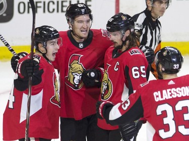 Ottawa Senators right wing Mark Stone, second left, celebrates his first-period goal with teammates Jean-Gabriel Pageau, left, Erik Karlsson and Fredrik Claesson, right.