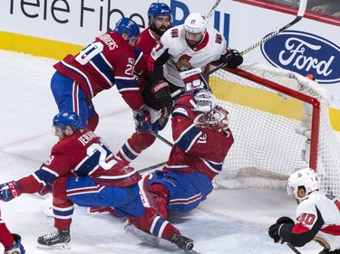 Montreal Canadiens goaltender Carey Price is knocked over by the Ottawa Senators' Nate Thompson.