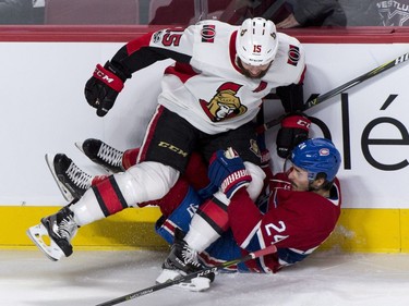 The Senators' Zack Smith crushes the Montreal Canadiens' Phillip Danault along the boards.