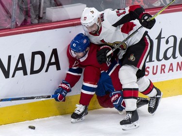 The Montreal Canadiens' Paul Byron is overpowered by the Ottawa Senators' Nate Thompson.