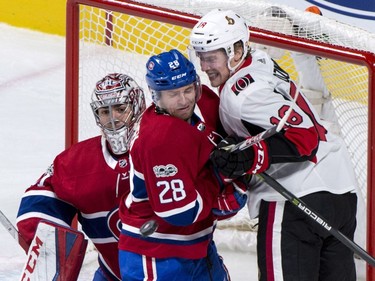 Montreal Canadiens defenceman Jakub Jerabek takes out the Ottawa Senators' Ryan Dzingel from in front of goaltender Carey Price.