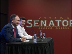 Senators general manager Pierre Dorion, left, joins centre Matt Duchene at a media conference at Canadian Tire Centre on Monday. THE CANADIAN PRESS/Justin Tang