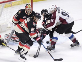 Ottawa Senators Erik Karlsson (65) keeps the puck away from goalie Craig Anderson (41) and Colorado Avalanche Gabriel Landeskog (92) during second period NHL hockey action in Ottawa, Thursday, March 2, 2017.