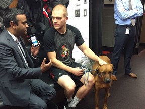 Senators defenceman Mark Borowiecki, with Remi at his side, does an interview with Ian Mendes of TSN 1200 AM Radio in the Senators locker room on Monday morning. Whatever has been troubling him, he says “there are certain things that take precedence over hockey,” and he’s grateful for a team that has “bent over backwards” to give him some time away.