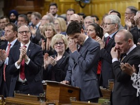 Prime Minister Justin Trudeau wipes his eye while he is applauded while making a formal apology to individuals harmed by federal legislation, policies, and practices that led to the oppression of and discrimination against LGBTQ2 people in Canada, in the House of Commons in Ottawa, Tuesday, Nov. 28, 2017.