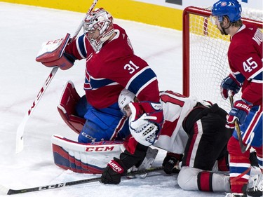 The Ottawa Senators' Derick Brassard falls next to Canadiens goaltender Carey Price during first-period NHL action Wednesday, Nov. 29, 2017 in Montreal.