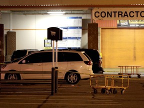 A vehicle is surrounded by a police perimeter in the parking lot of a Home Depot store, Tuesday, Oct. 31, 2017, in Passaic, N.J. Police investigating a rented Home Depot truck's deadly rampage down a bike path near New York's World Trade Center have surrounded the white Toyota minivan with Florida plates parked in the lot. (AP Photo/Julio Cortez)