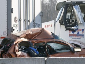OPP investigate an accident on Highway 401 just east of Prescott Ontario Tuesday Nov 28, 2017. A Quebec trucker was arrested early Tuesday morning hours after two people were killed in a five-vehicle crash late Monday on Highway 401. Four people were also taken to hospital after the crash at about 10:30 p.m. Monday between Prescott and Highway 416, one of them by air ambulance with life-threatening injuries.