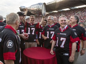 Ottawa Mayor Jim Watson, hoists the Grey Cup after the announcement that Ottawa will host the 2017 CFL Grey Cup game at TD Place Arena in Ottawa Sunday, July 31, 2016.
