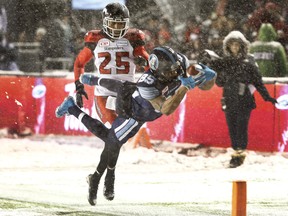 Argonauts DeVier Posey beats Calgary's Tommie Campbell to the end zone on a 100-yard catch-and-run and dives across the line for a touchdown during first half action at the Grey Cup. Tony Caldwell/Postmedia