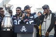 Argonauts quarterback Ricky Ray looks over at James Wilder Jr. as he speaks to fans gathered in Nathan Phillips Square on Nov. 28, 2017