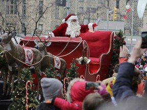 Thousands of people gathered along Wellington Street, Bank Street and Laurier Avenue to take in the Help Santa Toy Parade festivities in downtown Ottawa on Nov. 19, 2016. (David Kawai)
