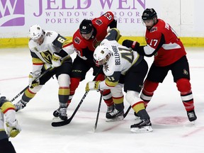 Vegas Golden Knights and Senators players scramble for a loose puck during their game at Canadian Tire Centre yesterday. The Sens lost 5-4. (The Canadian Press)