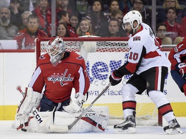 Washington Capitals goalie Braden Holtby (70) and Ottawa Senators left wing Tom Pyatt (10) watch the puck during the first period of an NHL hockey game, Wednesday, Nov. 22, 2017, in Washington.