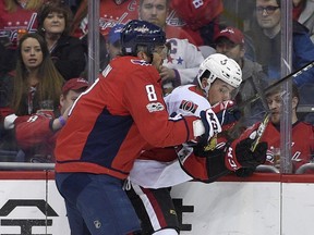 Washington Capitals left wing Alex Ovechkin (8), of Russia, checks Ottawa Senators defenseman Cody Ceci into the boards during the first period of an NHL hockey game, Wednesday, Nov. 22, 2017, in Washington.