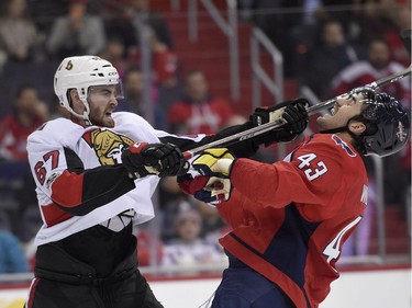 Ottawa Senators defenseman Ben Harpur (67) swings his stick at Washington Capitals right wing Tom Wilson (43) during the second period of an NHL hockey game, Wednesday, Nov. 22, 2017, in Washington.