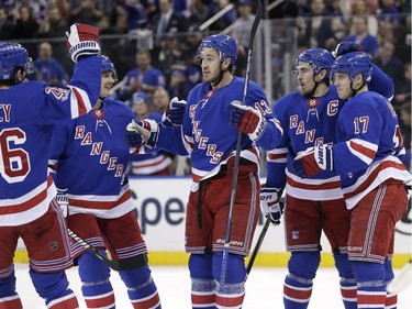 New York Rangers' Kevin Hayes, center, celebrates his goal with teammates during the second period of the NHL hockey game against the Ottawa Senators, Sunday, Nov. 19, 2017, in New York. (AP Photo/Seth Wenig)