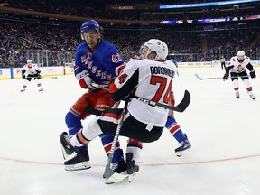 New York Rangers' Brendan Smith takes a five-minute major and a game misconduct for his interference on Ottawa Senators' Mark Borowiecki during the third period at Madison Square Garden on Nov. 19, 2017 in New York City.  (Bruce Bennett/Getty Images)