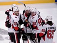 Senators defenceman Fredrik Claesson, left, celebrates with teammates after scoring his team's first goal against the Avalanche at Stockholm on Friday. Erik Simander/TT via AP