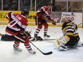 Ottawa 67's Travis Barron shoots on Kingston Frontenacs goalie Jeremy Helvig as 67's Mitchell Hoelscher drives the net during Ontario Hockey League action at the Rogers K-Rock Centre on Sunday, Nov. 19 2017. (Ian MacAlpine/Postmedia Network)