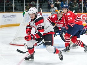 Travis Barron of the 67’s chases a loose puck into the corner while Generals’ Ian Blacker looks on last night in Ottawa. (Submitted photo)