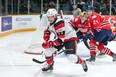 Travis Barron of the 67’s chases a loose puck into the corner while Generals’ Ian Blacker looks on last night in Ottawa. (Submitted photo)