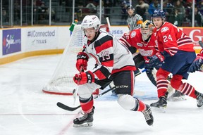 Travis Barron of the 67’s chases a loose puck into the corner while Generals’ Ian Blacker looks on last night in Ottawa. (Submitted photo)