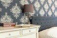 This damask wallpaper is a bold choice for a bedroom and an effective way to add an element of pattern to your home.