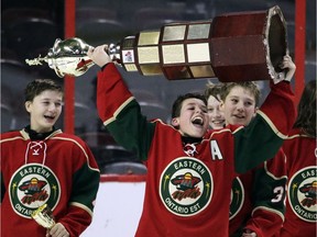 Eastern Ontario's Ethan Montroy hoists the trophy after the Wild's victory against the Capitals in the major peewee AAA final at Canadian Tire Centre on Sunday.
