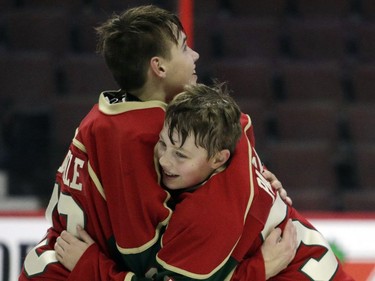 Eastern Ontario Wild goalie Mathis Mainville, left, celebrates winning the major peewee AAA championship final against Providence Capitals with teammate Mathieu Paris.