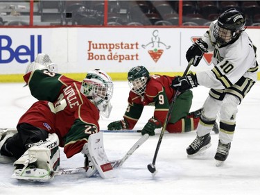 Eastern Ontario goalie Mathis Mainville makes a save against Providence's Owen Leahy during the major peewee AAA final on Sunday.