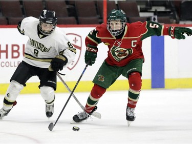 Wild captain Carey Terrance, right, tries to elude the Capitals' Cameron Smith during the major peewee AAA championship game.