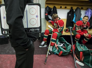 Eastern Ontario Wild players get ready in the dressing room before facing the Providence Capitals.