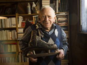 Jean-Marie Leduc, 78, poses with a skates worn by Montreal Canadiens' and NHL Hall of Fame player, Emile "Butch" Bouchard, in his Ottawa home Tuesday January 13, 2015. Leduc has around 350 pairs of skates including a pair of bison bone skates dating back 15,000 years.