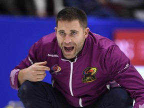 John Morris makes a call during a draw against Team Jacobs at the Roar of the Rings on Saturday.
(THE CANADIAN PRESS)
