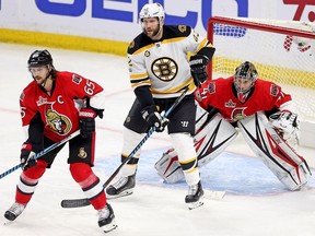 Erik Karlsson (from left) David Backes and Craig Anderson look for the puck as the Ottawa Senators take on the Boston Bruins in game five of round one in the NHL playoffs.